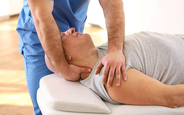 Physiotherapist working with elderly patient in clinic